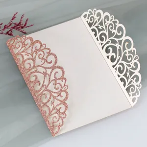 Close-up of laser-cut rose gold glitter and ivory floral wedding invitation cover
