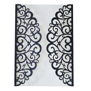 Close-up of laser-cut glitter navy invitation with intricate hollow floral patterns