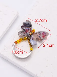 Detail view showing 2.7cm butterfly ring dimensions with beaded accents and silver band