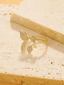 Detailed view of an adjustable butterfly ring with leaves and sparkling white zircons