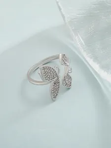 Detailed macro of a silver butterfly and leaf open ring with shimmering pavé zircon stones