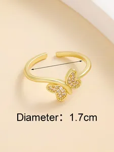 Detail of gold butterfly ring with zircon pave stones and 1.7cm diameter measurement