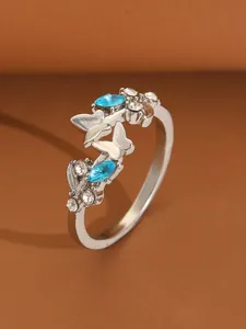 Detailed shot of silver butterfly open ring featuring blue marquise-cut rhinestones