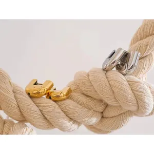 Polished chunky U-shaped hoop earrings in gold and silver finish hanging on jute rope