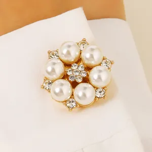 Elegant pearl flower cufflink with rhinestones on a white sleeve cuff