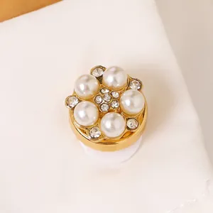 Elegant gold floral cufflink with white pearls and sparkling rhinestone center