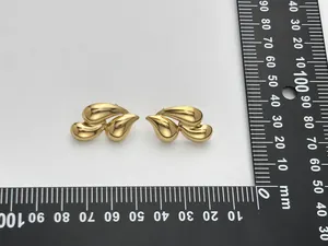 Close-up of 18K gold-plated teardrop earrings with measuring scale showing 25mm size