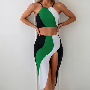 Detail of color block three-piece swimsuit showing contrast panels and side slit skirt