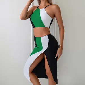 Detail of high-slit midi skirt and color-block top in green, white and black