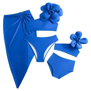 Three-piece royal blue family bikini set with 3D floral accents and matching beach sarong
