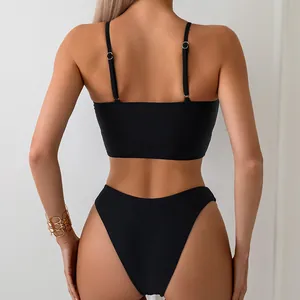 Rear view of minimalist black three-piece bikini with adjustable straps and high cut bottom