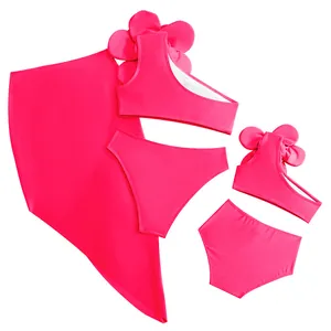 Detail of rose red parent-child swimwear with 3D floral accents and wrap skirt