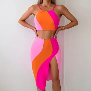 Detailed view of three-piece swimsuit featuring contrast wavy color blocks and side slit skirt
