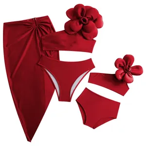 Three-piece dark red bikini set featuring large 3D floral detail and matching sarong skirt