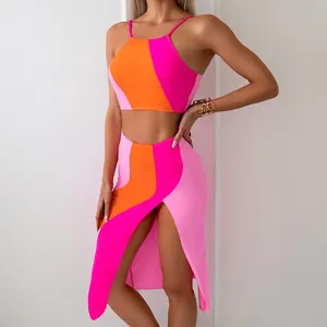 Detailed close-up of high-waist side slit skirt in orange and pink color block fabric