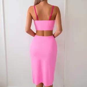 Rear view of neon pink two-piece set featuring adjustable straps and a high waist skirt
