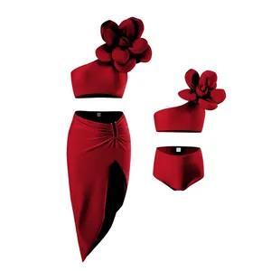 Detailed view of dark red three-piece bikini set with 3D floral accent and slit skirt