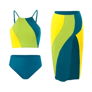 Detailed view of women's three-piece swimwear featuring a color-block bikini and matching skirt