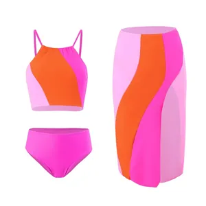 Detailed flat lay of three-piece color-block swimsuit with high-waist skirt in bright pink