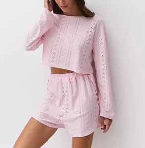 Detail of pink hollow-out knit set featuring breathable geometric patterns on fabric