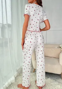 Detail of cherry print pajamas set showing ruffle edges and ribbed fabric texture