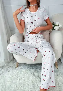 Detail of cherry print fabric texture with red ruffled edges on pajama set