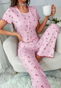 Detail of pink cherry print pajama set with lettuce edge trim and front buttons for women