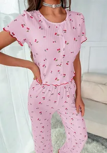 Close-up of pink cherry print pajama set with lettuce trim and vertical ribbed texture