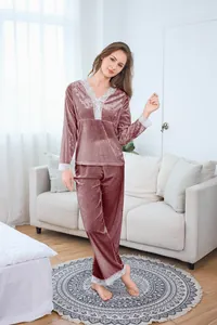 Detailed close-up of velvet pajamas with delicate lace trim on sleeves and V-neckline