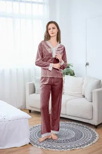 Close-up of pink velvet pajama set with white lace trim and decorative waist bow