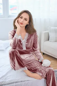 Pink velvet pajama set with white lace trim and bow detail on the V-neck and cuffs