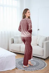 Detailed view of elegant pink velvet pajamas featuring intricate white lace trim on sleeves