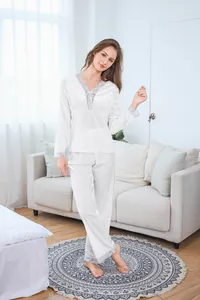 Detailed texture of white velvet pajama set with elegant lace trim on sleeves and cuffs