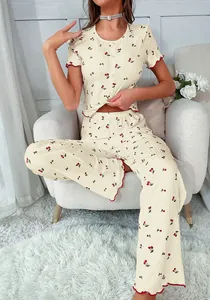 Detail of cherry print pajamas set with red ruffle trim on ribbed knit fabric