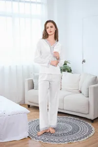 White velvet pajama set with light blue lace trim details in a cozy home setting