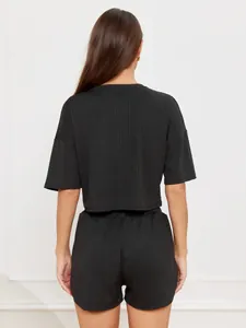 Detail view of the ribbed knit fabric back on this black crop top and shorts loungewear set
