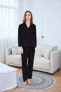 Detail of minimalist black velvet pajamas set with long sleeves and pocket for women
