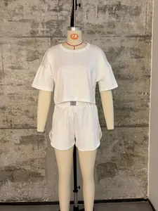 Detail of white ribbed lounge set showing elastic waistband with Fashion label on shorts