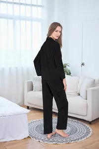 Detail of black velvet pajama set featuring long sleeves and loose trousers on a model