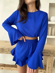 Detail of ribbed knit loungewear set in royal blue with ruffle hem shorts and flared sleeves
