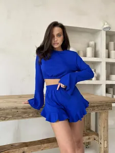 Detail of electric blue ribbed long sleeve crop top and ruffle hem shorts set