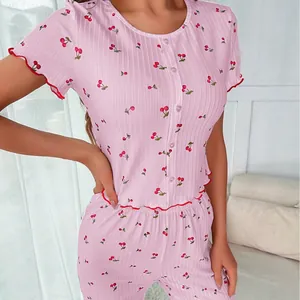 Pink cherry print pajama set with short sleeves, long pants and red ruffle trim edges