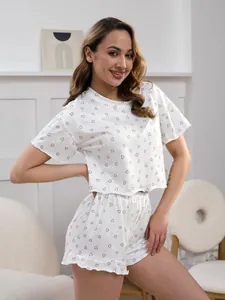 Detail of white pajamas with black heart prints and sweet ruffled hem shorts