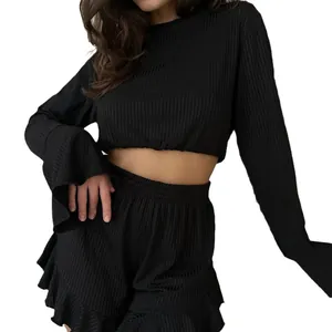 Women's black ribbed loungewear set with long sleeve crop top and ruffled shorts