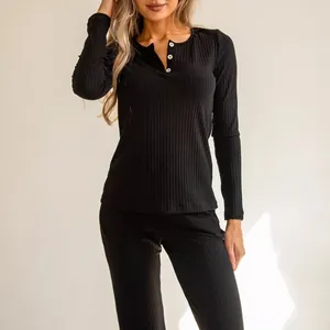Women's black ribbed loungewear set with long sleeves, henley neck and matching pants