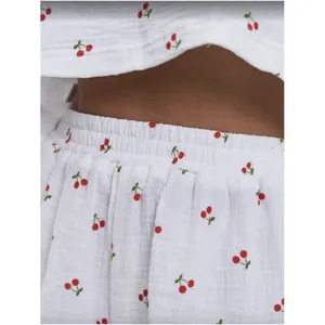 Detail of cotton crepe pajamas with red cherry print and elastic waistband texture