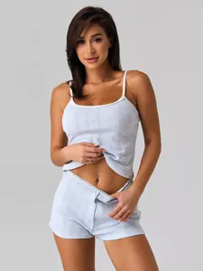 Close-up of light blue ribbed knit camisole and shorts set with hollow dot pattern details