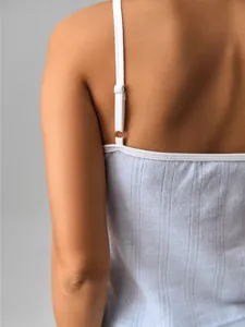 Close-up of lightweight openwork knit fabric texture and adjustable thin straps