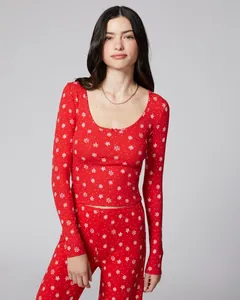 Detail of red two-piece Christmas pajama set featuring snowflake patterns and ribbed texture
