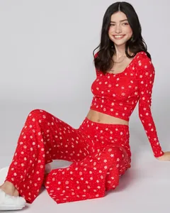 Detail of red Christmas pajama set featuring white snowflake patterns and elastic fabric